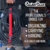 A person holds a bundle of coiled A/V cables secured with a red Coil'n'Carry® Strap. Text: The professional’s choice for organizing, carrying, and hanging A/V cables. Drums appear in the background.