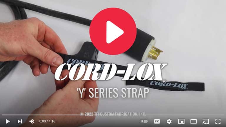 Close-up of hands securing a Coil'n'Carry® Strap around an electrical cord and plug. Large play button overlays the image. Text reads Coil'n'Carry® Strap and © 2022 TFI Custom Fabrication, Inc.