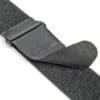 A close up of a VELCRO® Brand VELSTRAP® Strap in black partially fastened with its plastic buckle and textured surface visible for securing items