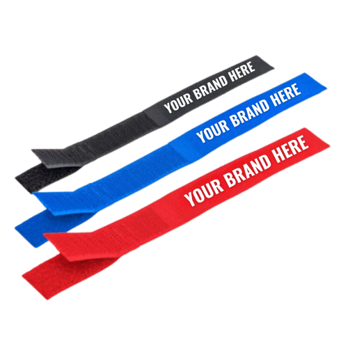 Three fabric cable ties in black blue and red each labeled YOUR BRAND HERE in white text are arranged diagonally on a white background TFI Custom Fabrication Three fabric cable ties in black blue and red each labeled YOUR BRAND HERE in white text are arranged diagonally on a white background