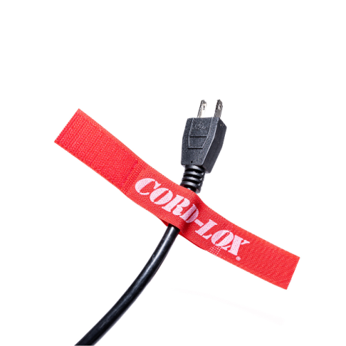 A black electrical cord secured with a red hook and loop cable tie labeled CORD LOX on a white background