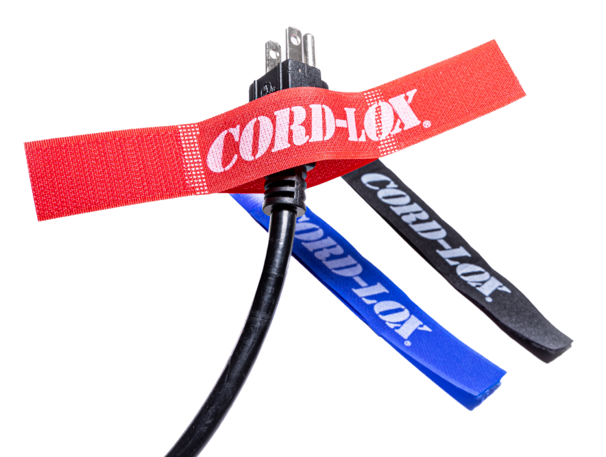 A black power cord bundled with red blue and black CordLox reusable cable ties each labeled CORDLOX in white text The red tie secures the plug while the others are shown open TFI Custom Fabrication A black power cord bundled with red blue and black Cord Lox reusable cable ties each labeled CORD LOX in white text The red tie secures the plug while the others are shown open