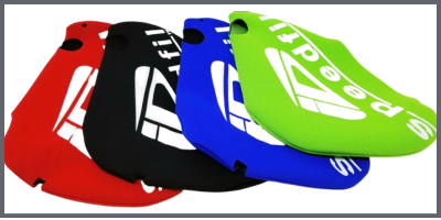 Four colored plastic Speedfil cycling accessoriesred black blue and greenare stacked side by side on a white background with bold white Speedfil logos visible on each item