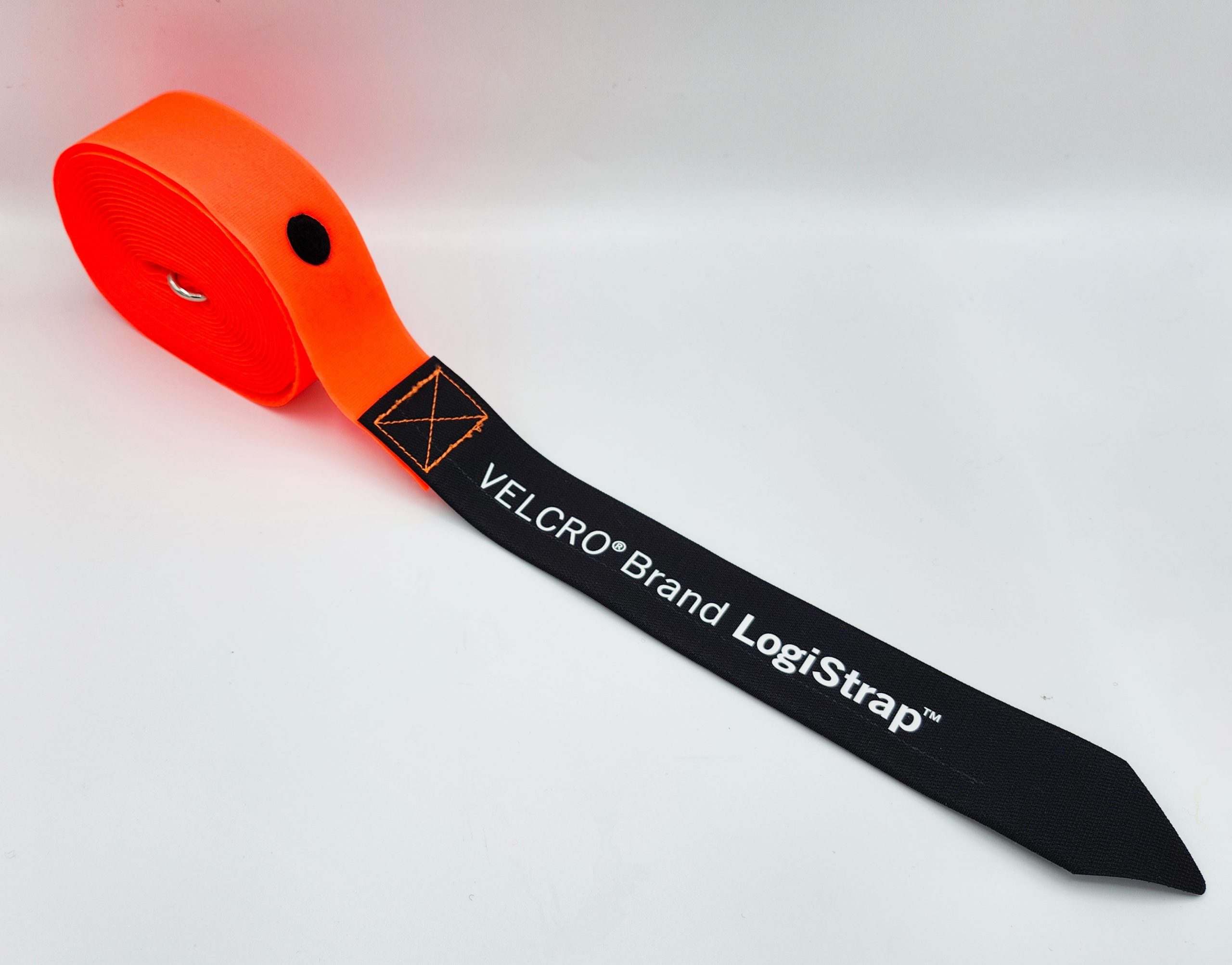 A rolled up orange strap with a black end labeled VELCRO Brand LogiStrap in white text displayed on a plain white background