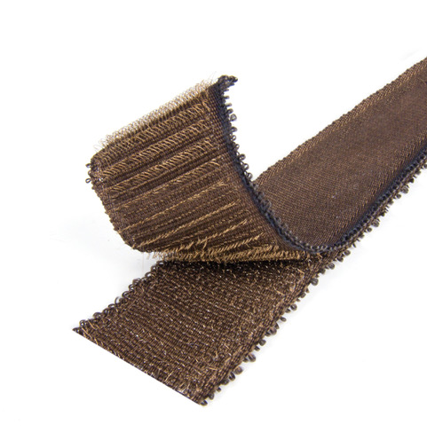 A close up of a VELCRO® Brand HI GARDE® Fastener a brown textured strip with a looped edge and partially rolled resembling an industrial strength hook and loop fastener