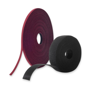 Two rolls of of VELCRO® Brand ONE-WRAP® fire retardant tape, one red and one black, are standing upright on a white background, with a section of tape pulled out from each roll.